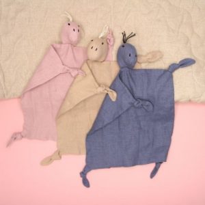 drie dino knuffeldoekjes op roze achtergrond met speelmat